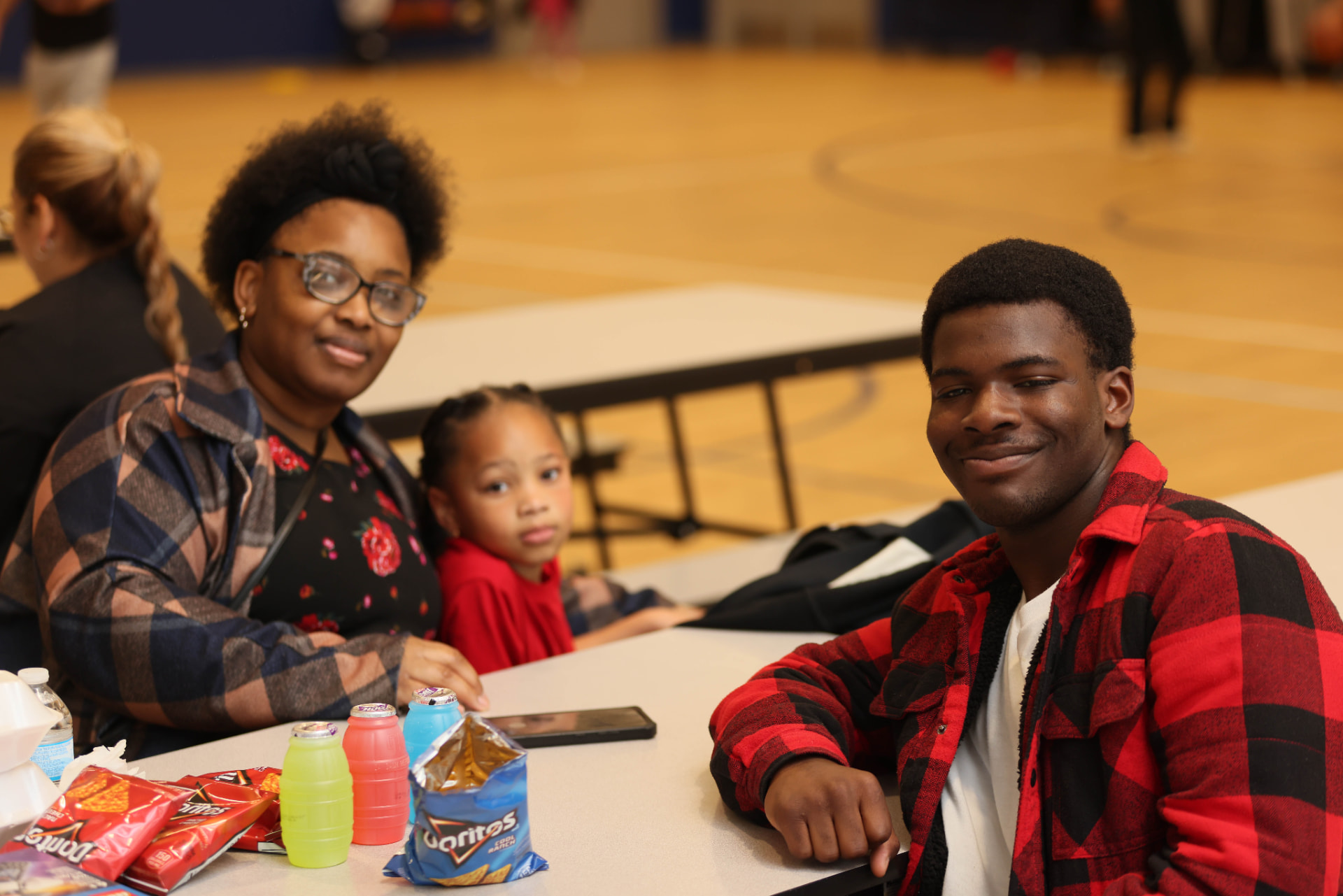 Family gathered at a ROOTED community event