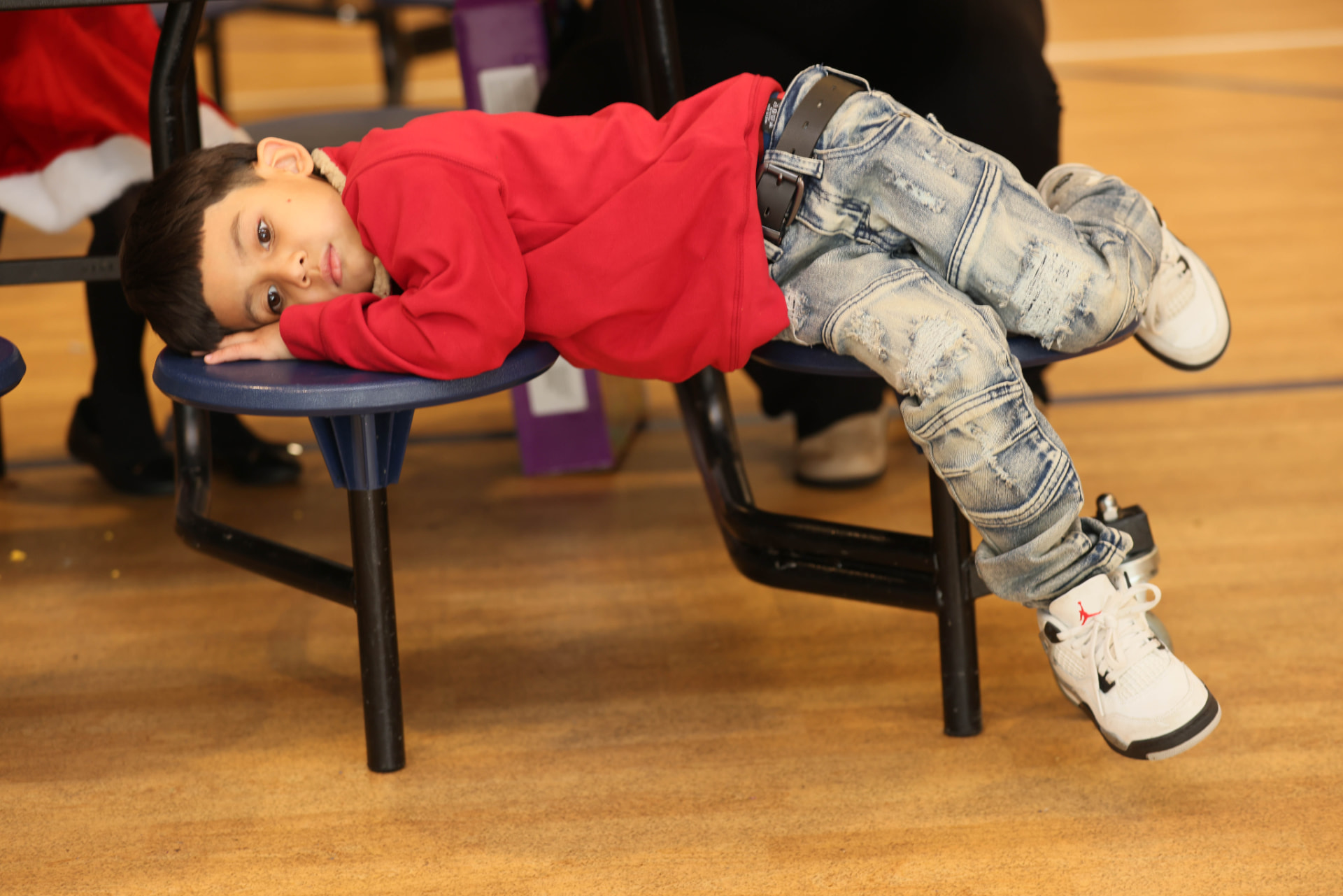 A young community member resting at a ROOTED learning event