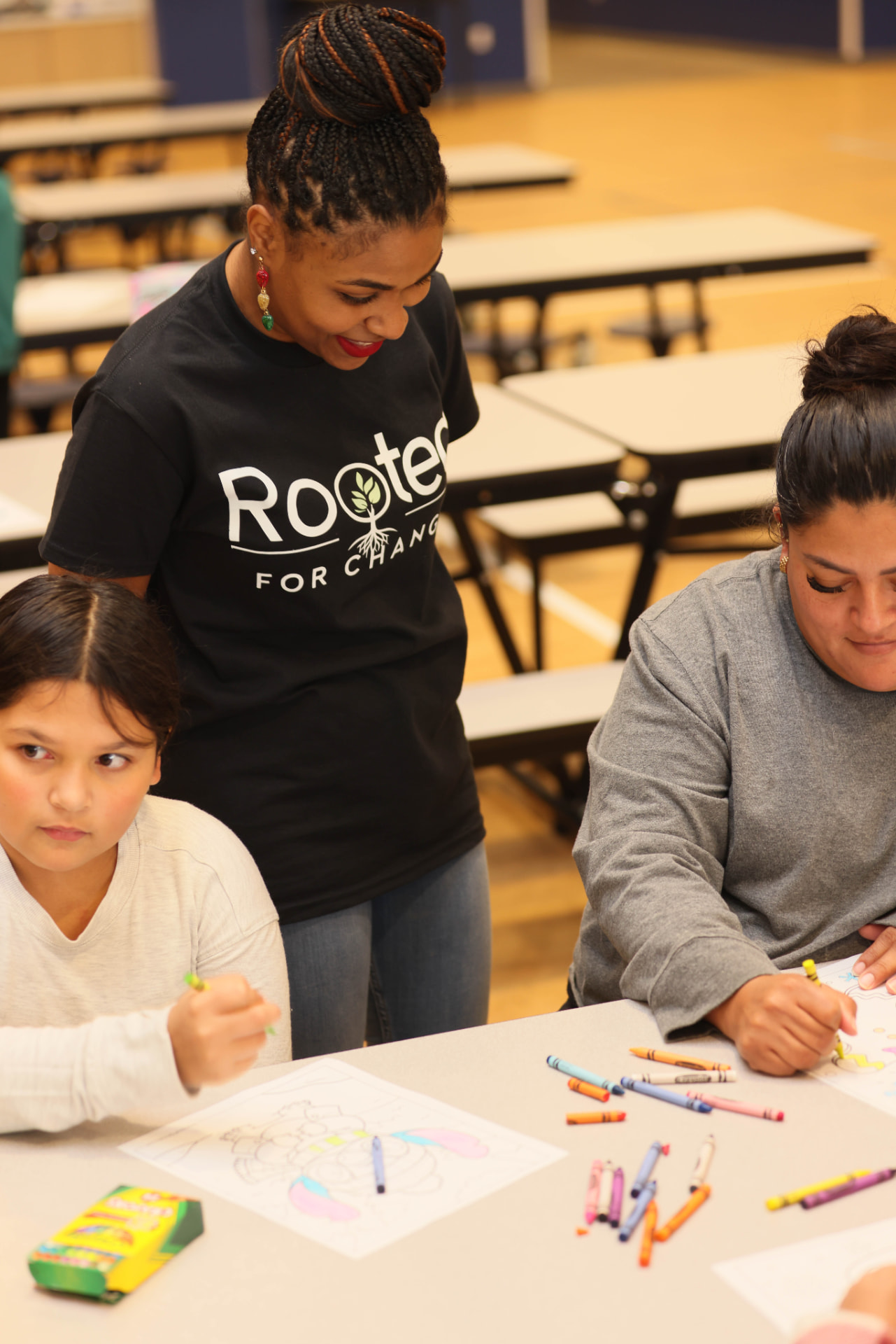 ROOTED for Change team member supporting families during a community activity