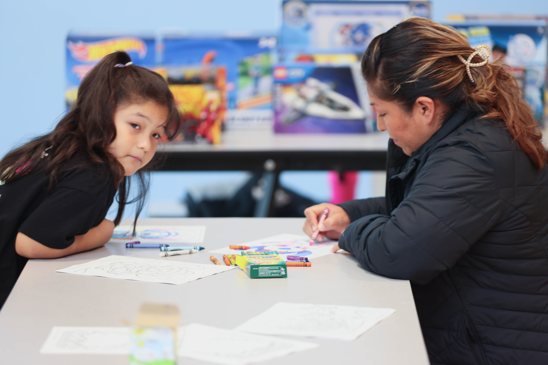 A ROOTED family creating art together at a community program